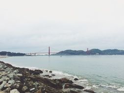 distant view of golden gate suspension bridge at coastline, usa, california, san francisco