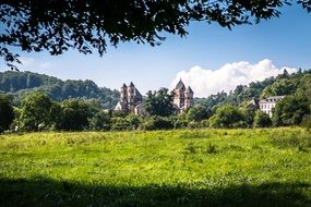 distant benedictine abbey in summer rural landscape