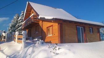 wooden house at snowy winter, croatia