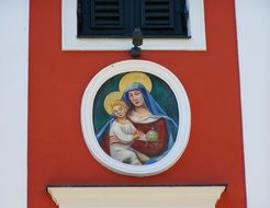 virgin mary and baby jesus, mural on old house, austria, lienz