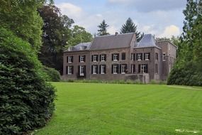 landscape of the old stone building on lawn in park