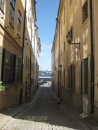 alley with cobblestone pavement in old town, sweden, stockholm, gamla stan