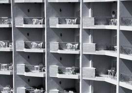 balconies with furniture on hotel facade