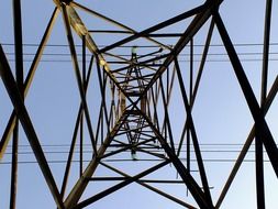 bottom view of electric power tower, metal construction at sky