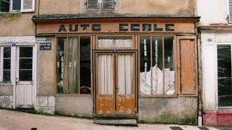 old abandoned facade of former auto school, france, burgundy, nièvre