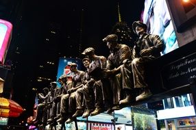 Iron workers sculpture on times square at night, usa, nyc