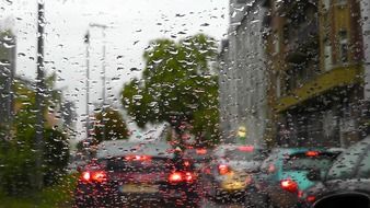 traffic on street through glass with raindrops