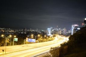 bright illuminated road in city at night, australia, sydney