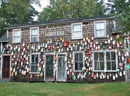 lot of colorful floats on facade of old building, usa, new england, maine