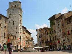 tourists on square in old town, italy, san gimignano