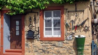 antique tools on facade of old village house