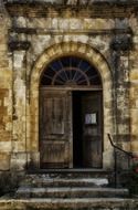 half open old wooden door of church, france