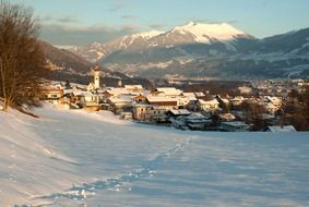 old village in mountain valley at winter