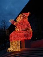 santa claus, christmas decoration on steps outdoor at dusk, germany, wolfsburg