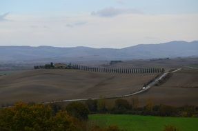 road across hills in beautiful rural landscape, italy, tuscany