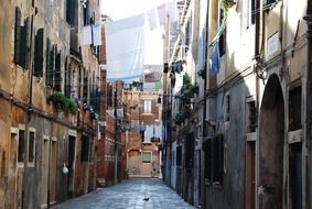 laundry on line across picturesque old alley, italy, venice