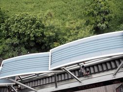 Top view of a covered escalator amid nature