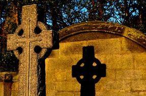 aged stone cross at wall