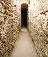 narrow walk path through old stone walls