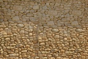 old yellow wild stone wall