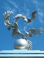 sculptures of storks taking flight on top of Mustakillik Square archway at sky, uzbekistan, tashkent
