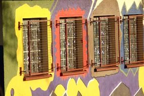 bright painted facade with grilles on lattice windows