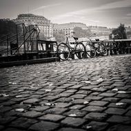 bicycles on embankment with cobblestone pavement in city
