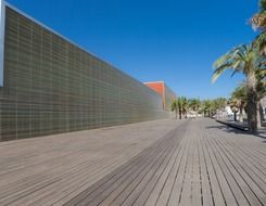 perspective of wooden walk path at wall on street