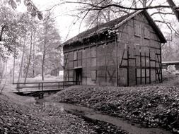 abandoned old building at brook in countryside