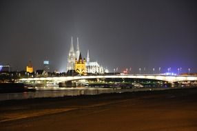 Illuminated colorful embankment of Cologne at night