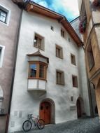 bicycle under bay window at wall, austria, rattenberg