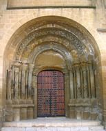 aged arched door of church building, spain, zaragoza