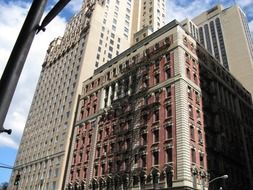 old building with staircase on facade at skyscraper, usa, new york city