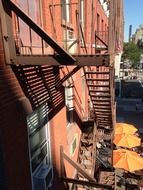 fire escape staircase on red brick facade in city