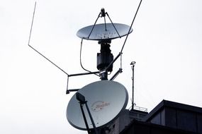 satellite dishes on roof at sky