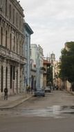 vintage cars at old buildings on street, cuba