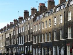 facades of old houses with chimneys on roofs, uk, england, london