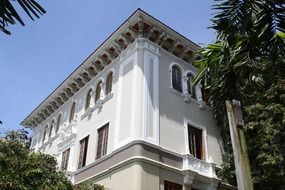 corner of old building among trees