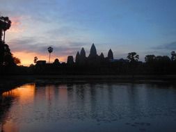 silhouette of angkor vat, ancient khmer temple, at sunrise sky, cambodia
