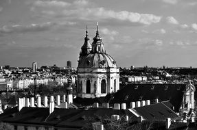 Church of Saint Nicholas domes among roofs of old buildings, czech, prague