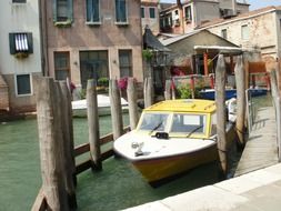 motor boats parked on channel at old buildings, italy, venice