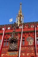 antique clock on painted facade of town hall building, switzerland, basel