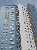 grey and blue facade of tall building, low angle view, germany