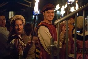 costimed happy people with torches in old town, austria, innsbruck