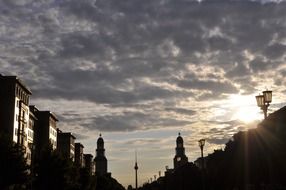 tv tower silhouette at evening sky among old buildings, germany, berlin, frankfurter tor