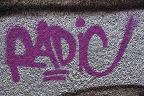 radio, purple grunge graffiti on grey wall