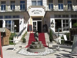 antique fountain at entrance to hotel, germany, ahlbeck