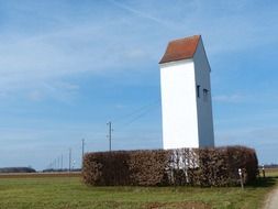 tower building on field in countryside