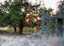 aged ruins in wilderness at sunset in israel, golan heights