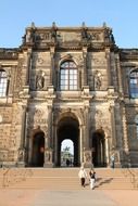 people on steps at gateway of zwinger palace, germany, dresden